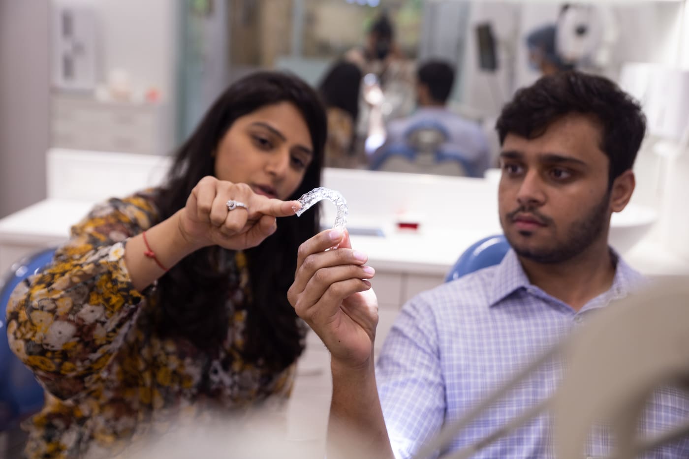 Dr. Upasana Gosalia explaining a clear aligner to a patient