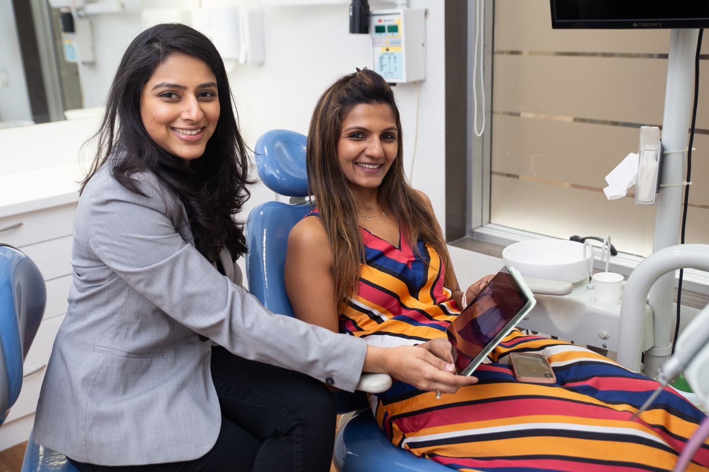 Dr. Upasana Gosalia showing a patient a digital smile preview on a tablet