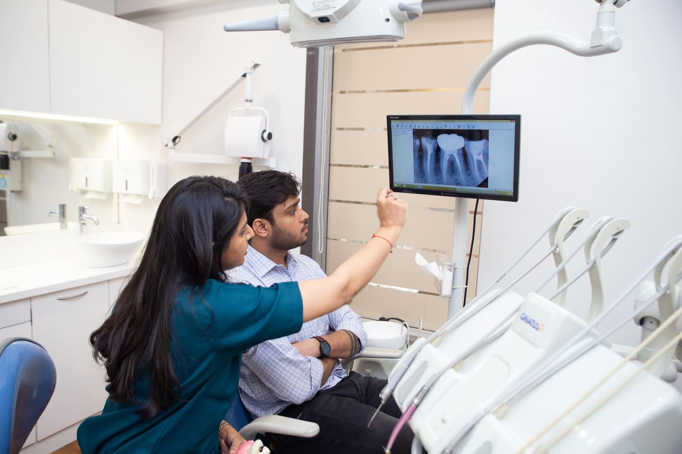 Dr. Upasana Gosalia explaining an X-ray to a patient on the chairside screen