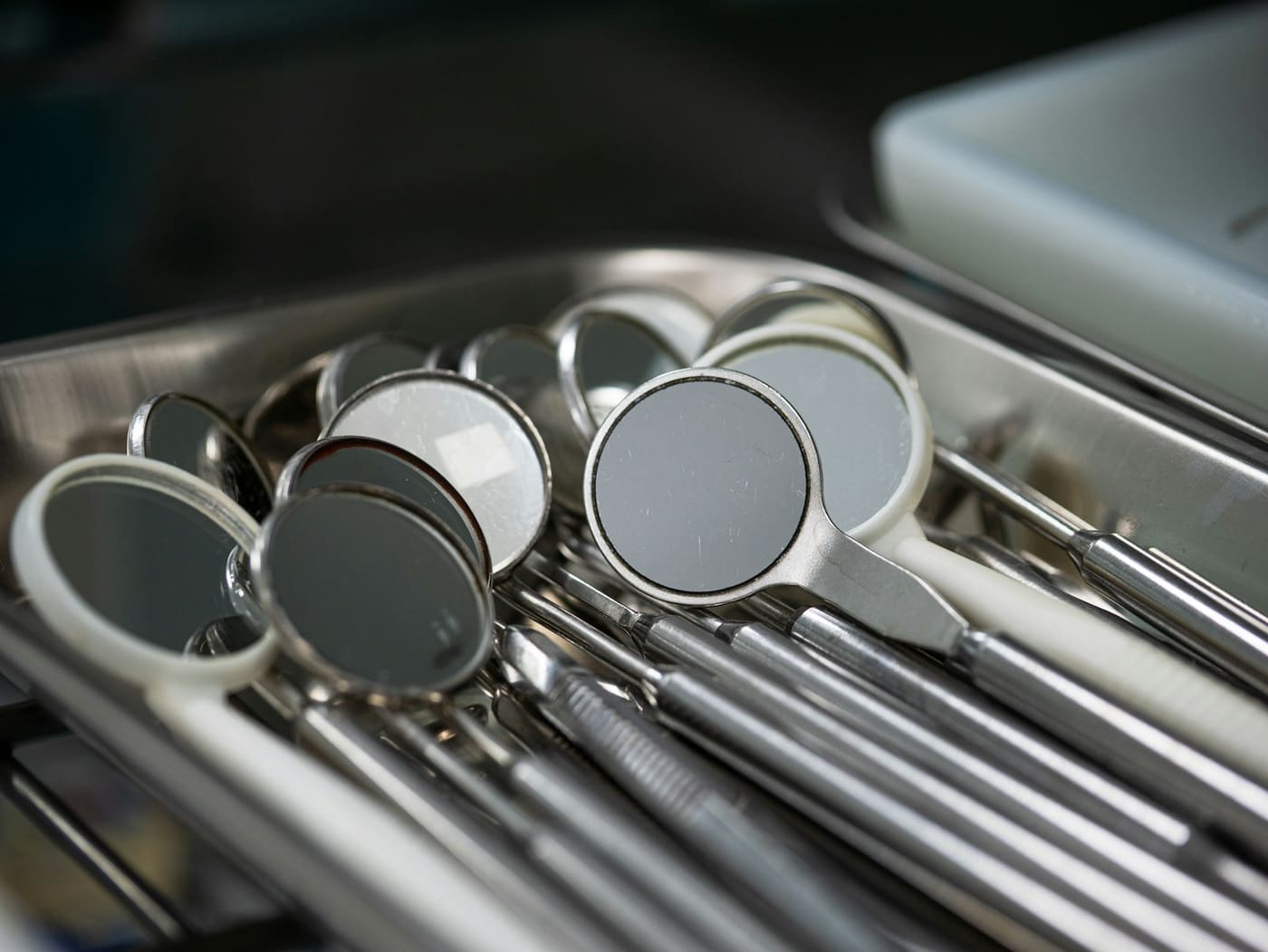Sterilised dental mirrors and instruments arranged in a tray